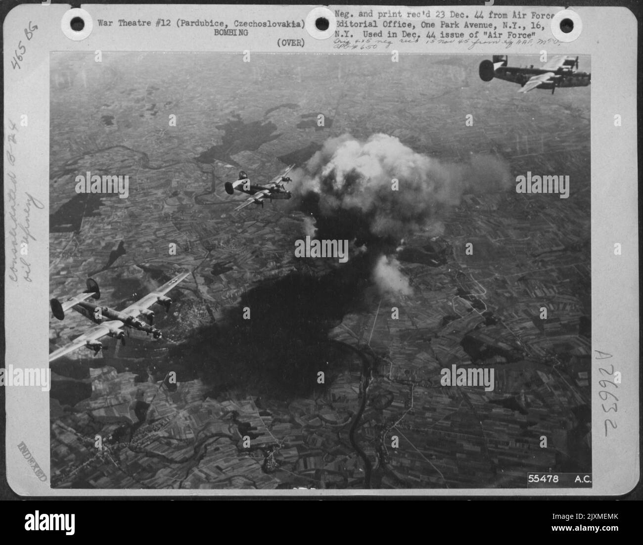 Giant column of smoke casts its shadow across the Czechoslovakia landscape as B-24 Liberators of the 15th A.A.F. come off the target area of the Pardubice oil refinery on August 24, 1944. Returning crewmen reported good concentration of bombs in the Stock Photo