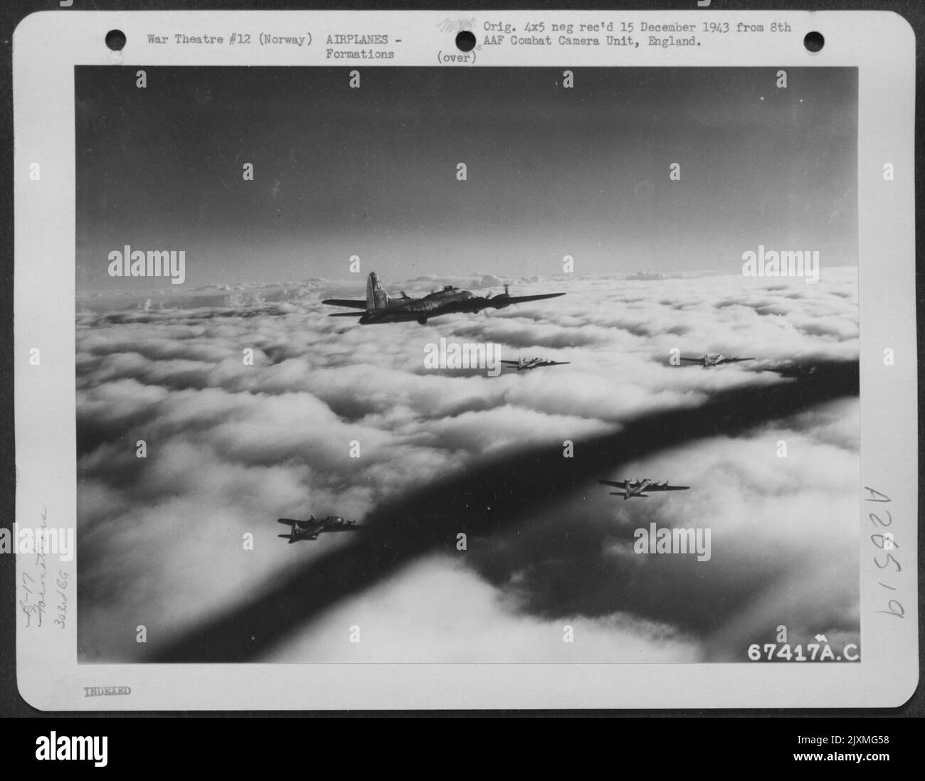 Flying high above a blanket of fleecy clouds, a formation of 8th Air Force Boeing B-17 'Flying Fortresses' drones steadily on toward the target somewhere in Norway on 16 November 1943. Stock Photo