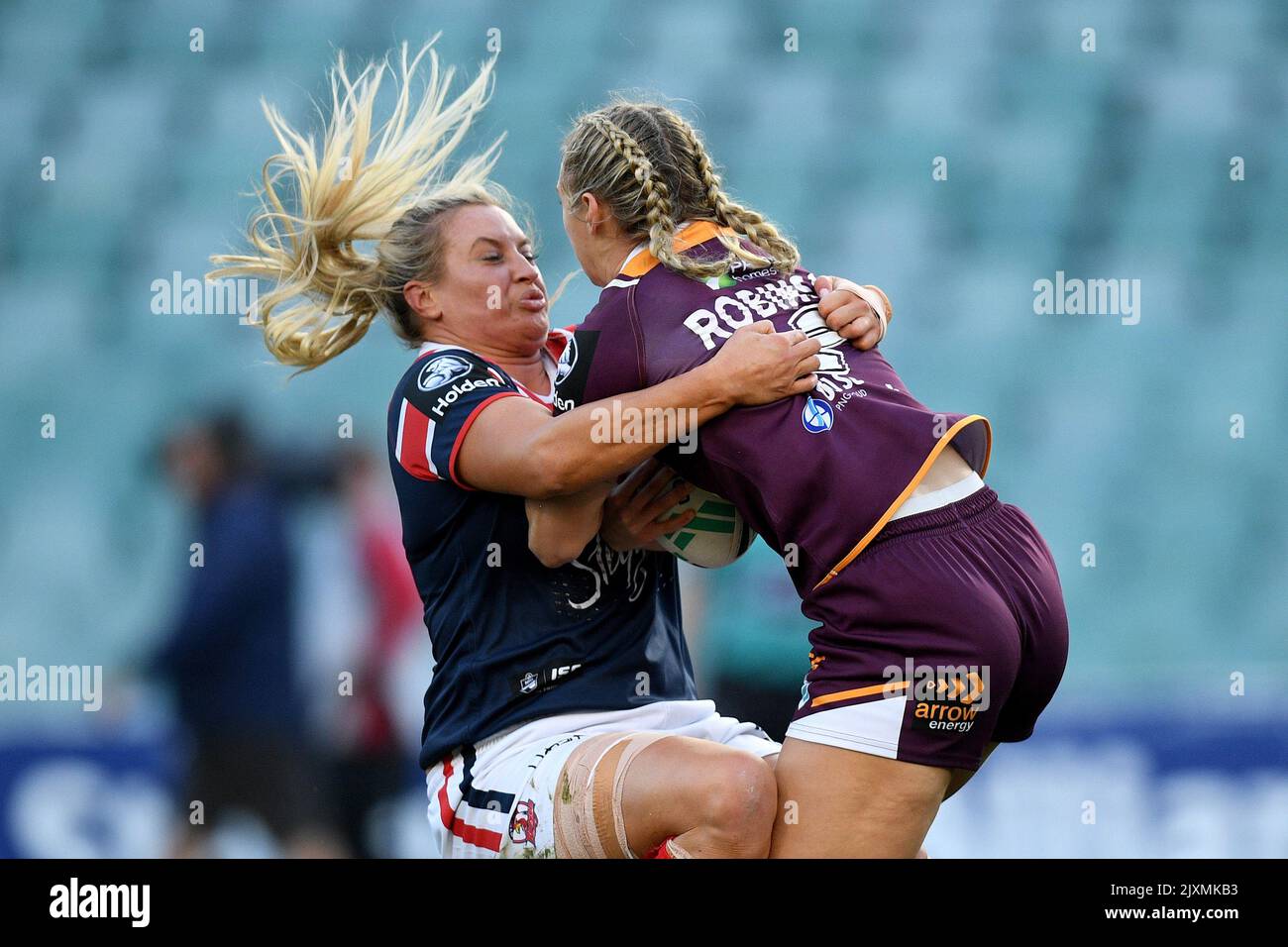 Julia Robinson (centre) of the Broncos is tackled by Holli Wheeler (left)  and Jessica Sergis (right) of the Dragons during the NRL Women's  Premiership match between the Brisbane Broncos and the St