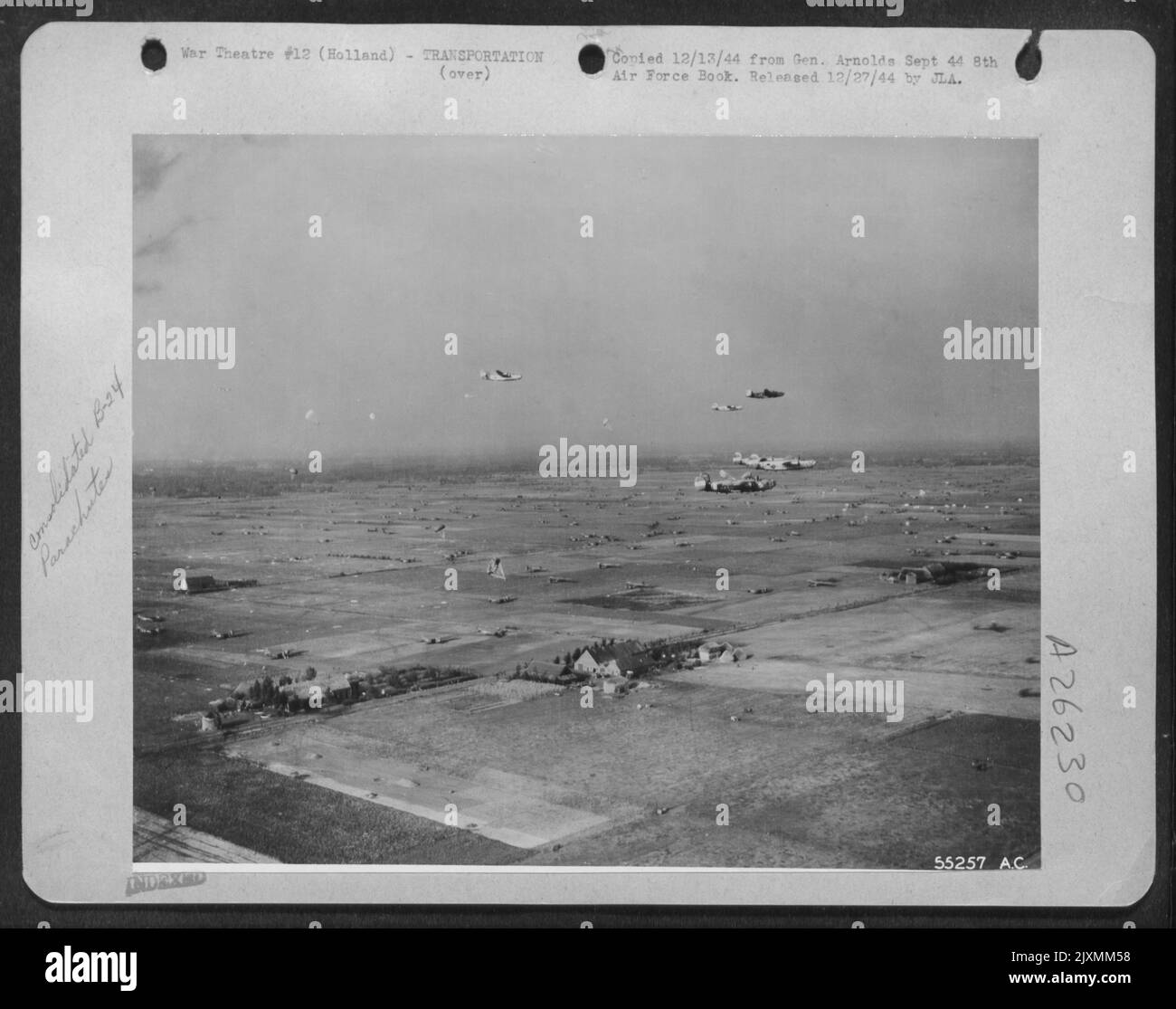 Supply laden chutes released by Consolidated B-24s drop in assigned area. Holland, 18 Sept 44. Stock Photo