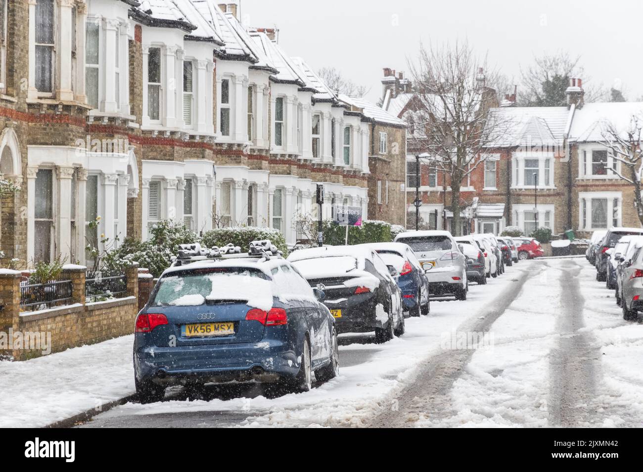 London street covered in winter snow around West Hampstead, England Stock Photo