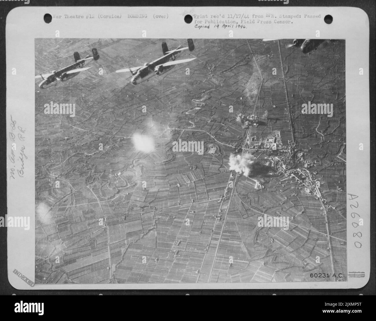 CORSICA-Part of a precision-bombing formation of North American B-25 Mitchell medium bombers is here shown nosing away from Saclir rail brige, which it has bombed into smoke and dust. The key rail structure was located 50 miles north Stock Photo