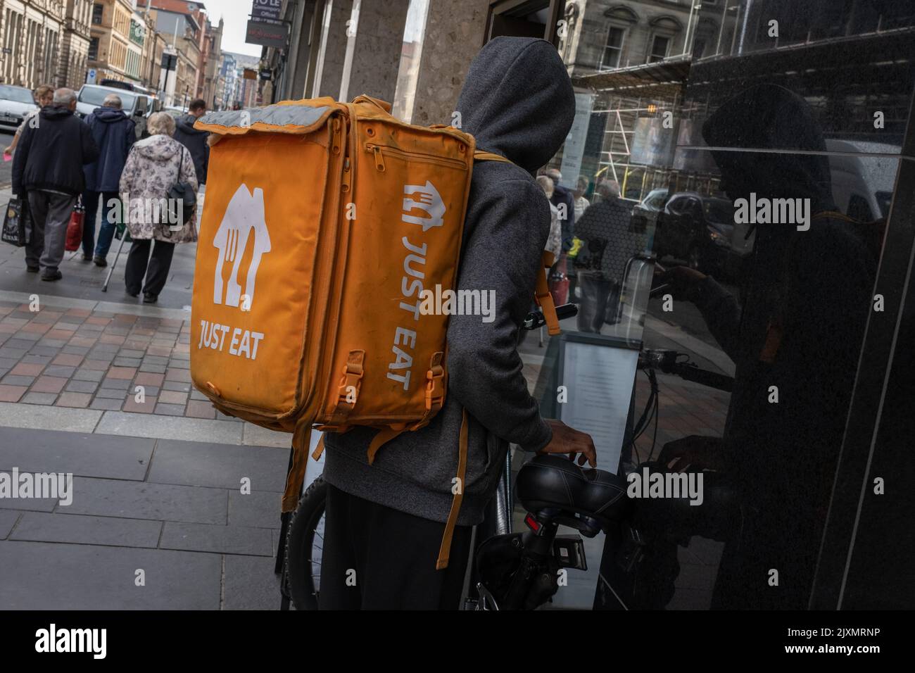 Fast food delivery bikers in the city streets, in Glasgow, Scotland, 7