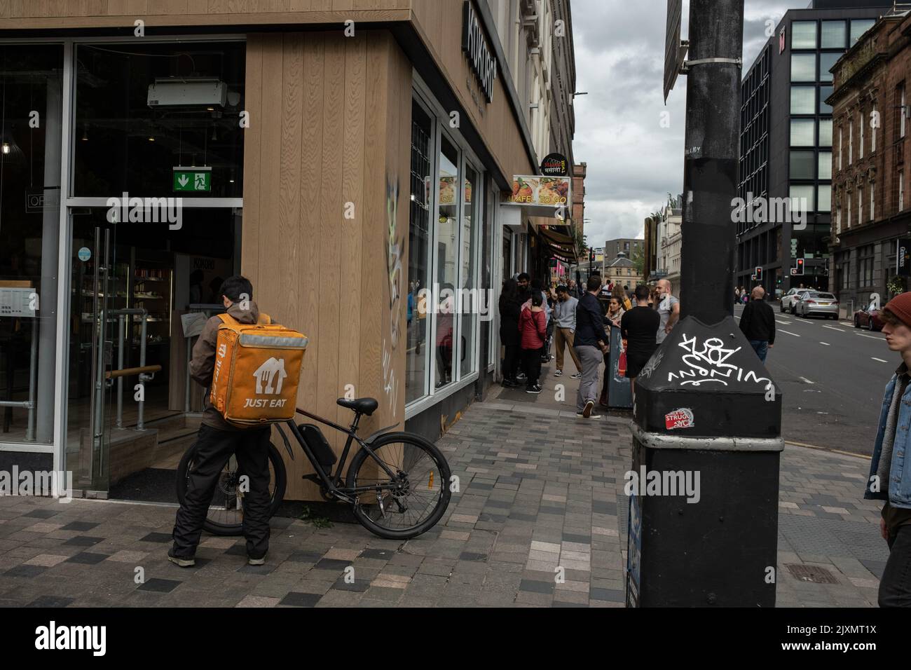 Fast food delivery bikers in the city streets, in Glasgow, Scotland, 7