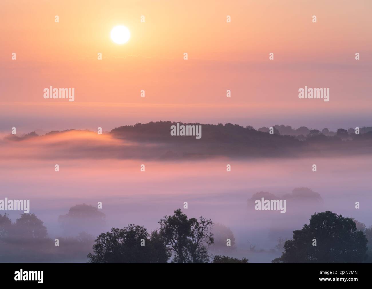 The sun rises over the rural landscape bordering the Vale of York on a warm, late summer morning. Stock Photo