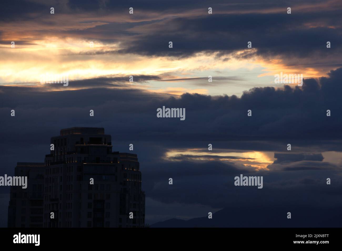Dramatic cloudy sky with a modern building Stock Photo - Alamy