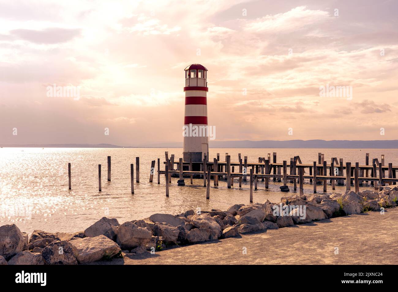 light house on pier in Podersdorf Austria next to Neusiedlersee at sunset Stock Photo