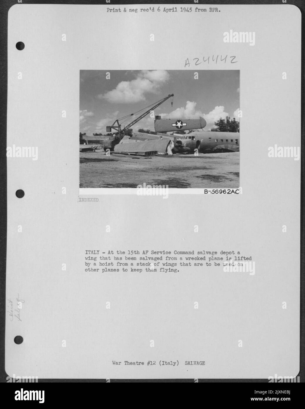 Italy - At A 15Th Af Service Command Salvage Depot A Wing That Has Been Salvaged From A Wrecked Plane Is Lifted By A Hoist From A Stack Of Wings Taht Are To Be Used On Other Planes To Keep Them Flying. Stock Photo
