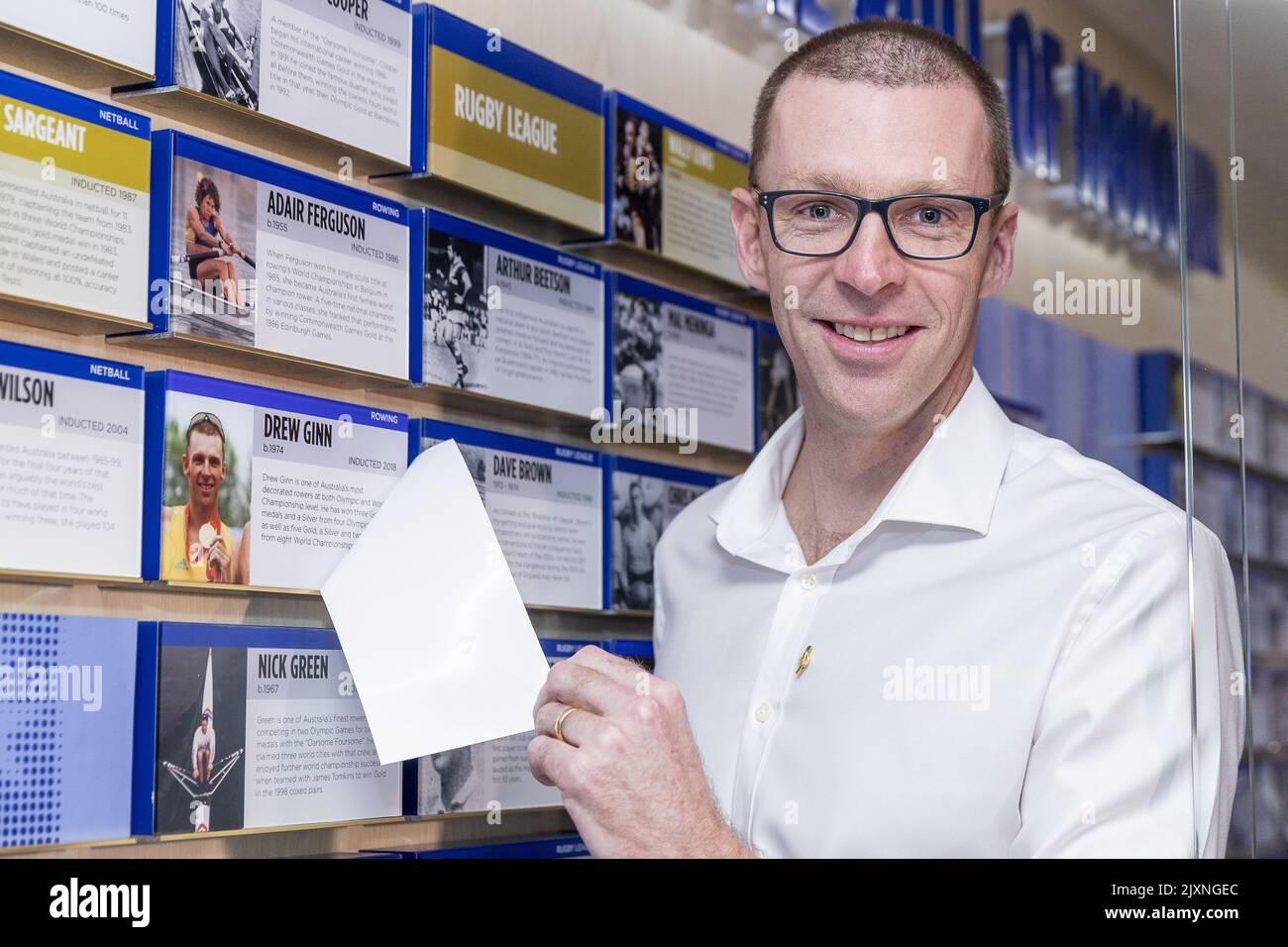 Drew Ginn poses for a photograph with his plaque during the 2018 Sport