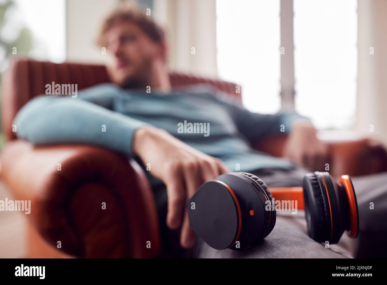 Relaxed man sitting on armchair hi-res stock photography and images - Alamy