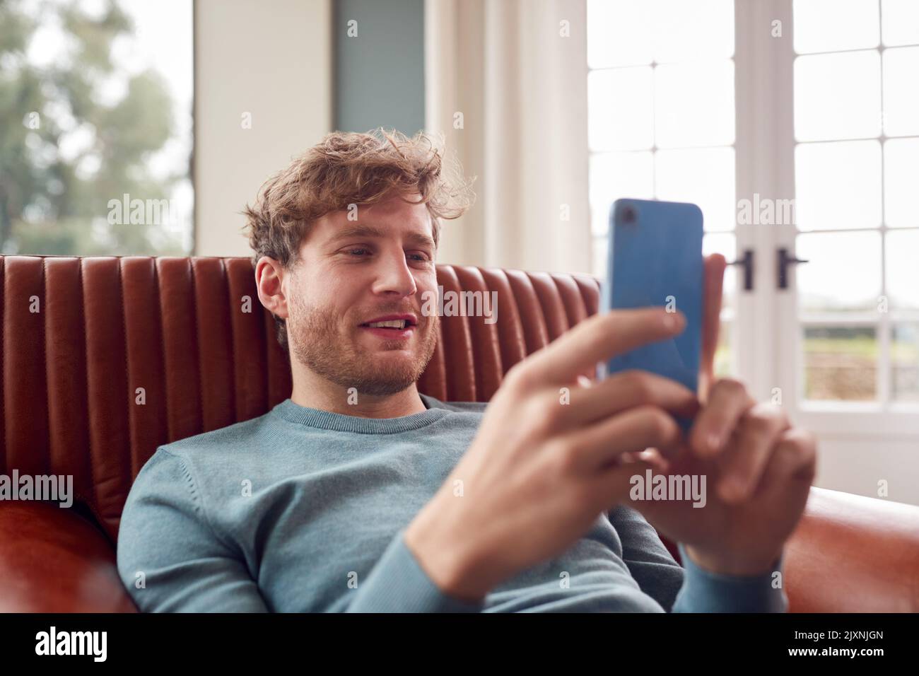 Relaxed man sitting on armchair hi-res stock photography and images - Alamy