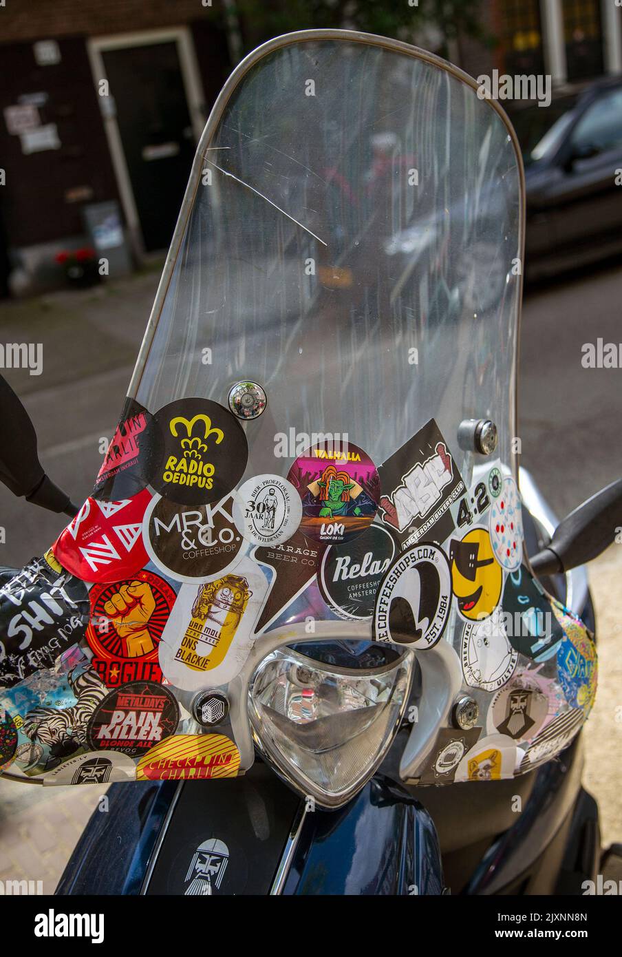 Windshield of a motor scooter covered with stickers Stock Photo