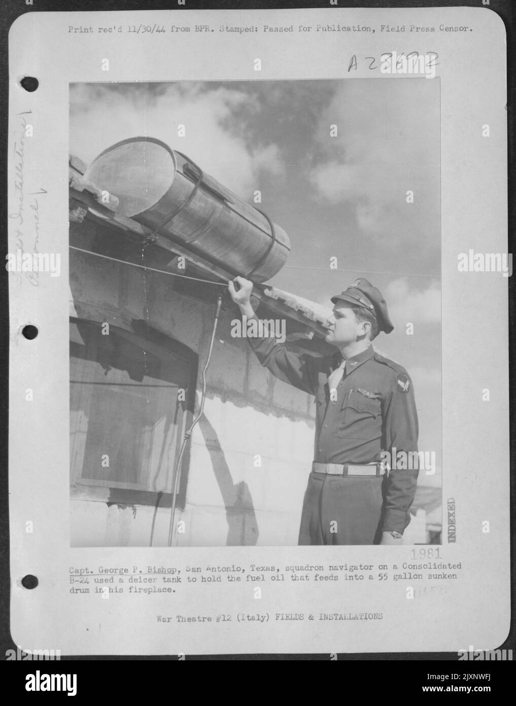 Capt. George P. Bishop, San Antonio, Texas, Squadron Navigator On A Consolidated B-24 Liberator Used A Deicer Tank To Hold The Fuel Oil That Feeds Into A 55 Galloon Sunken Drum In His Fireplace. Stock Photo