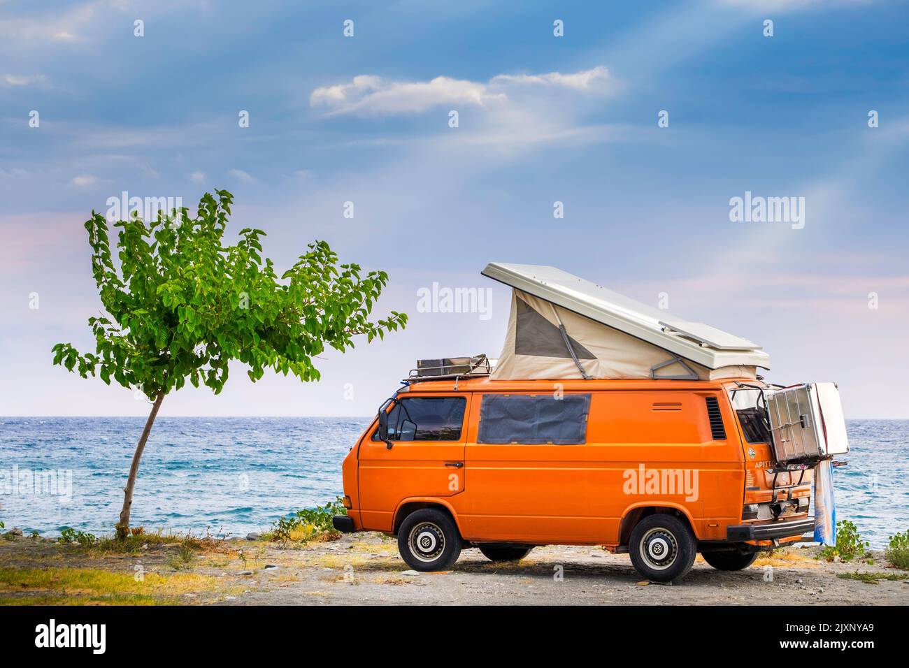 Volkswagen t3 camper Westfalia van or bus parked in the shore of Agiokampos beach ,Greece Stock Photo