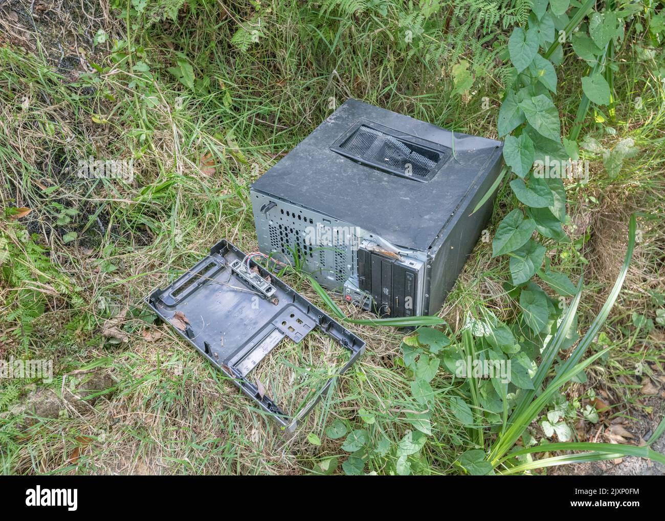 Abandoned old desktop PC / standalone computer dumped in a rural hedgerow - presumably to avoid recycling costs. For e-waste, unwanted computers. Stock Photo