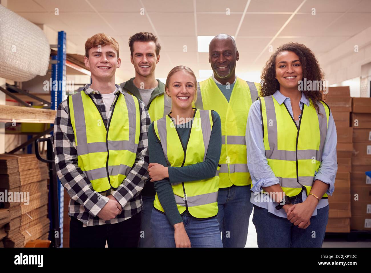 Portrait Of Multi-Cultural Team Wearing Hi-Vis Safety Clothing Working In Modern Warehouse Stock Photo