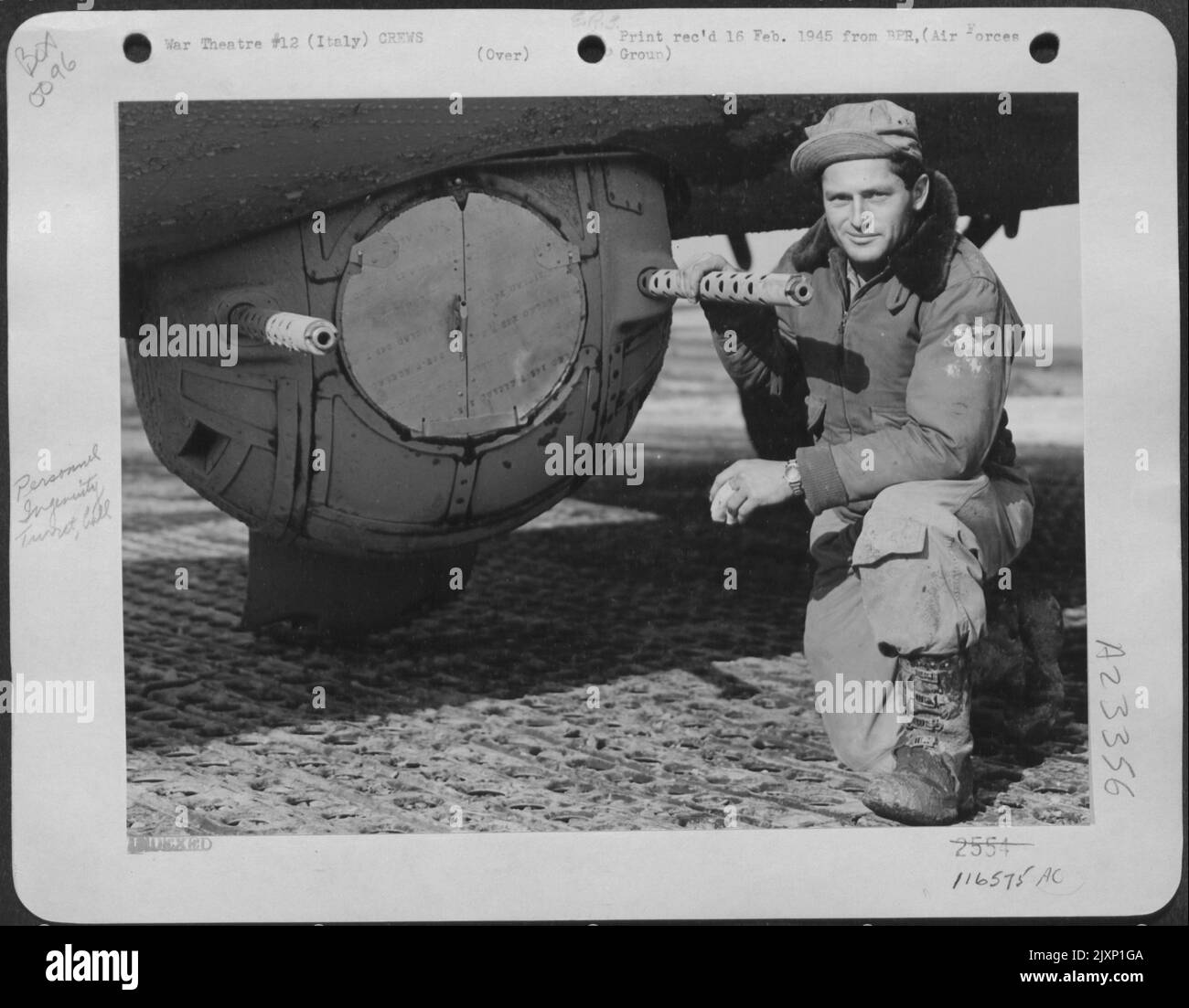 S/Sgt. George R. Fierbaugh, Palestine, Wv, Looking Grimly Satisfied, Poses By His Finished Product -- An Anti-Mud Cover To Keep His Boeing B-17 'Flying Fortress' Ball Turret Window Clean On Takeoff. By Grasphing The Handle Thru A Floor Hatch He Removes T Stock Photo