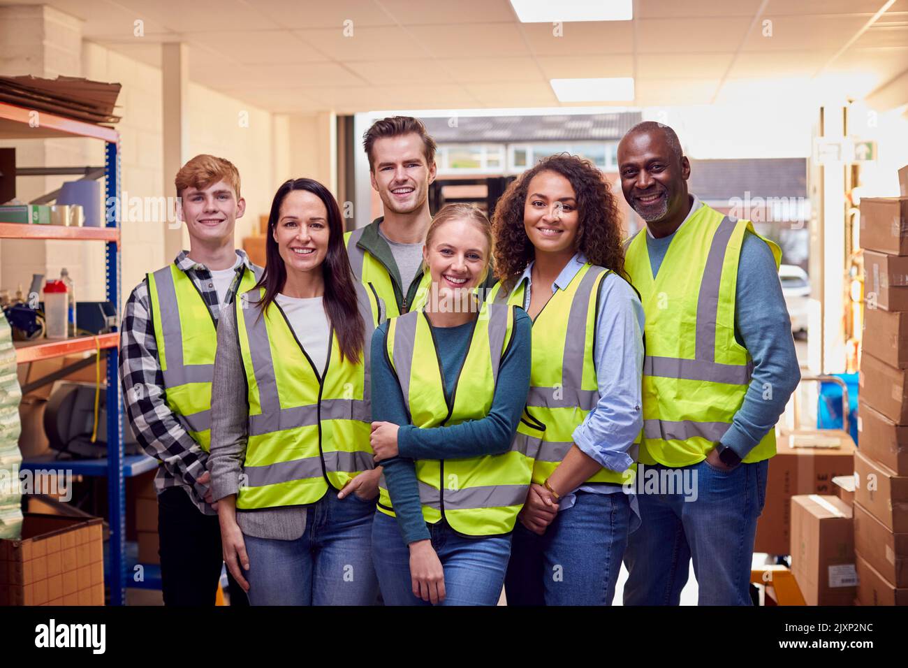 Portrait Of Multi-Cultural Team Wearing Hi-Vis Safety Clothing Working In Modern Warehouse Stock Photo