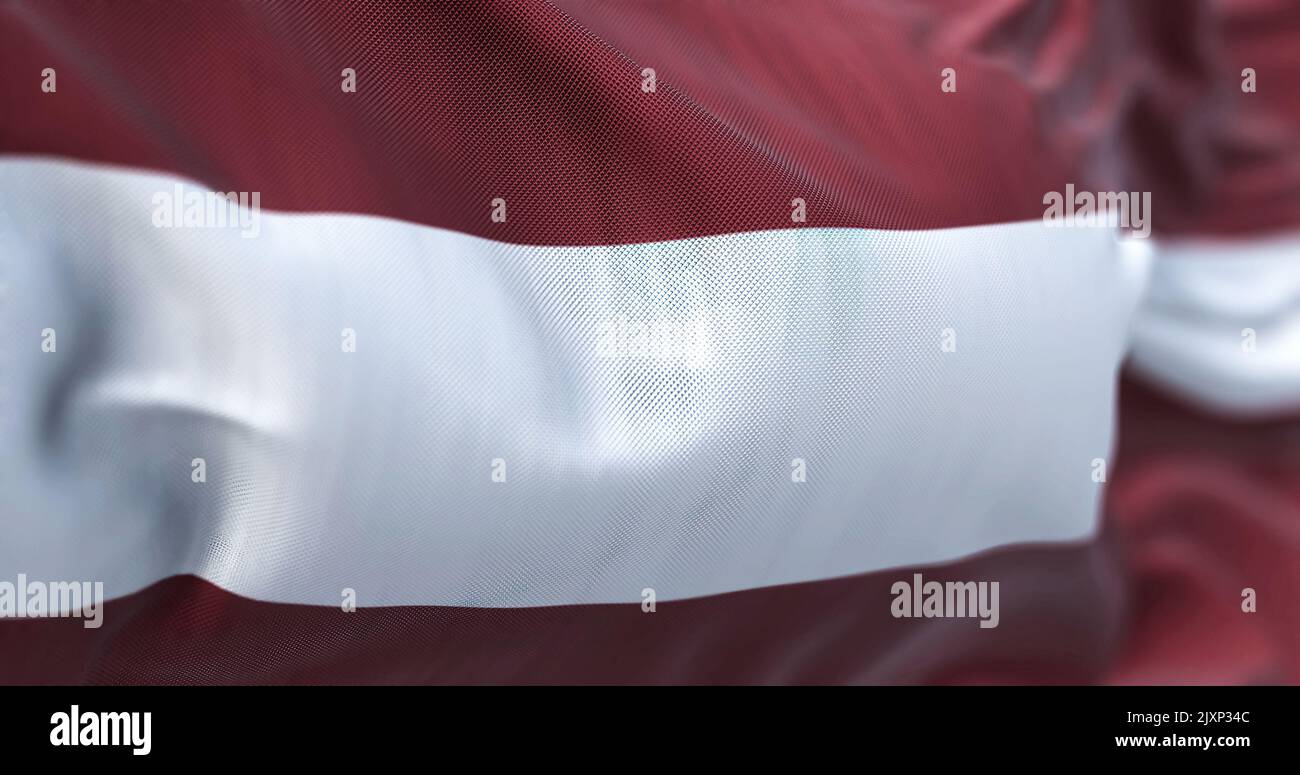 Close-up view of the latvian national flag waving in the wind. The Republic of Latvia is a country in the Baltic region of Northern Europe. Fabric tex Stock Photo