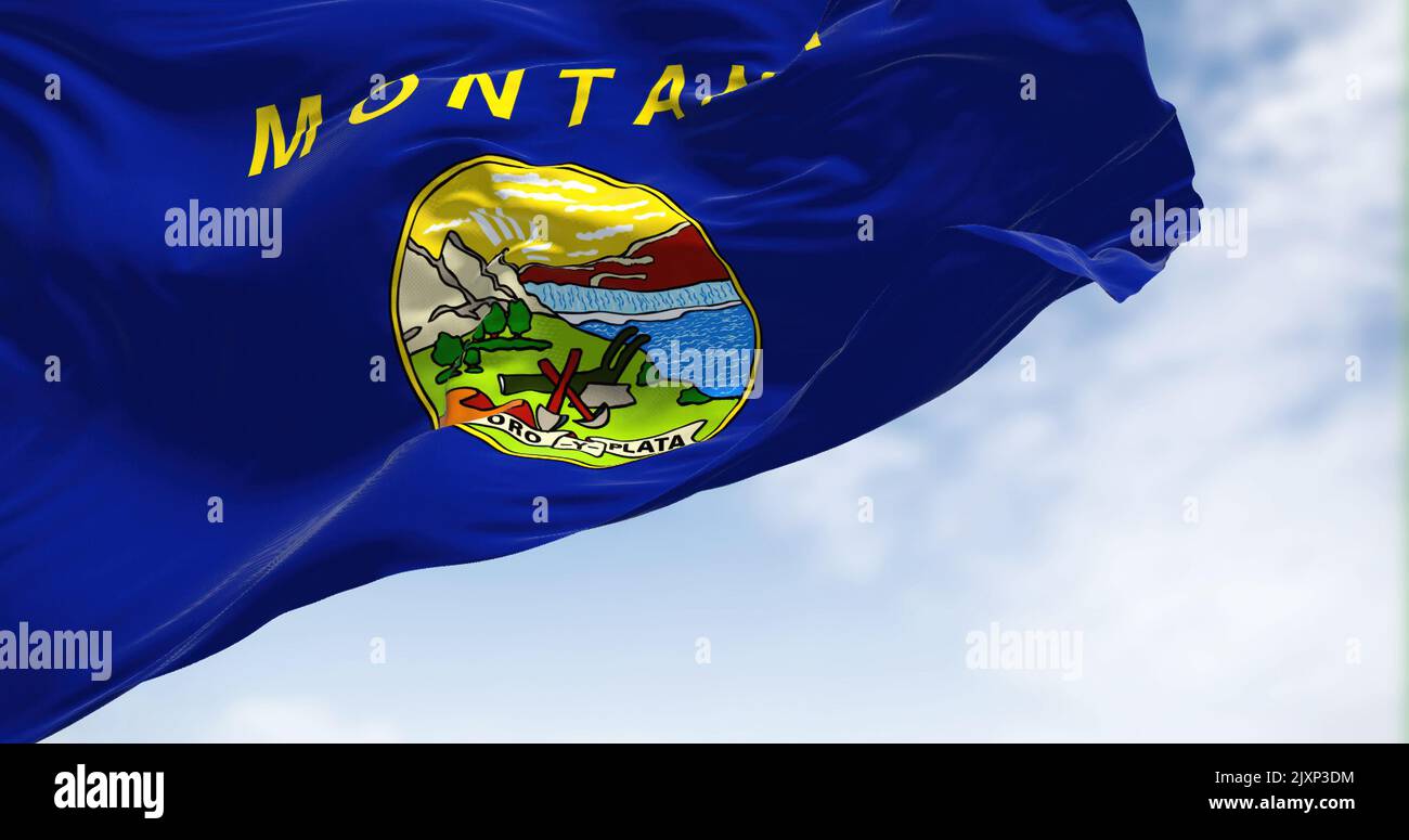 The US state flag of Montana waving in the wind. Montana is a state in the Mountain West subregion of the Western United States. Democracy and indepen Stock Photo