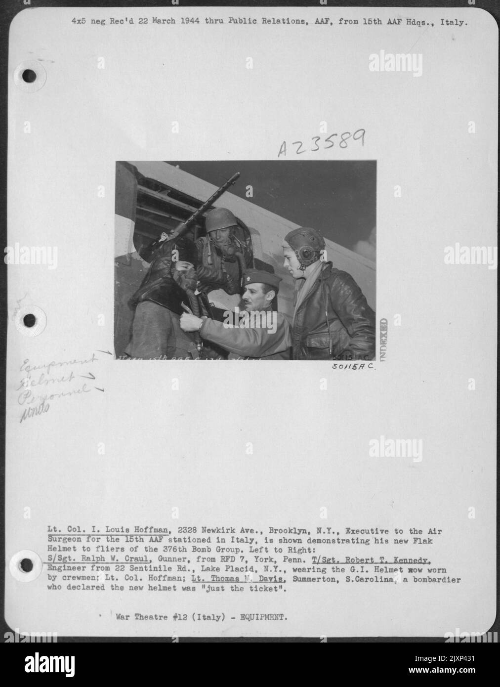 Lt. Col. I. Louis Hoffman, 2328 Newkirk Ave., Brooklyn, N.Y., Executive to the Air Surgeon for the 15th AAF stationed in Italy, is shown demonstrating his new Flak Helmet to fliers of the 376th Bomb Group. Left to Right: S/Sgt. Ralph W. Craul, Gunner Stock Photo
