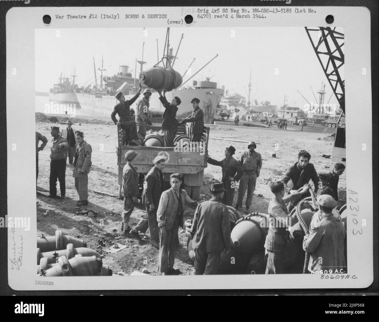 Italian Workers, Under The Supervision Of American Soliders, Load 1,000 Lb Bombs On Trucks For Removal To A Safer Place For Storage At Naples, Italy. 6 November 1943. Stock Photo