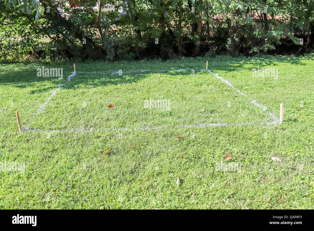 Lawn paint sprayed on grass for measurements for a shed Stock Photo