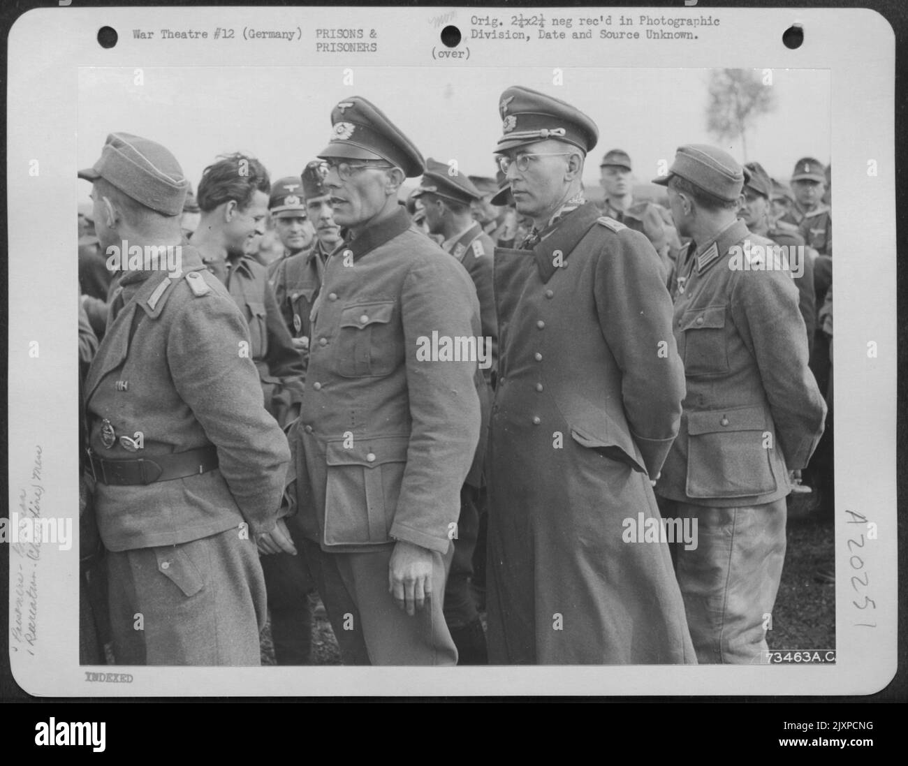 Captured German Officers Standing In Line Waiting For 'C' Rations At The Prisoner Of War Camp Near Hershfeld, Germany. Note Their Arrogance Even After Capture. 18 April 1945. Stock Photo