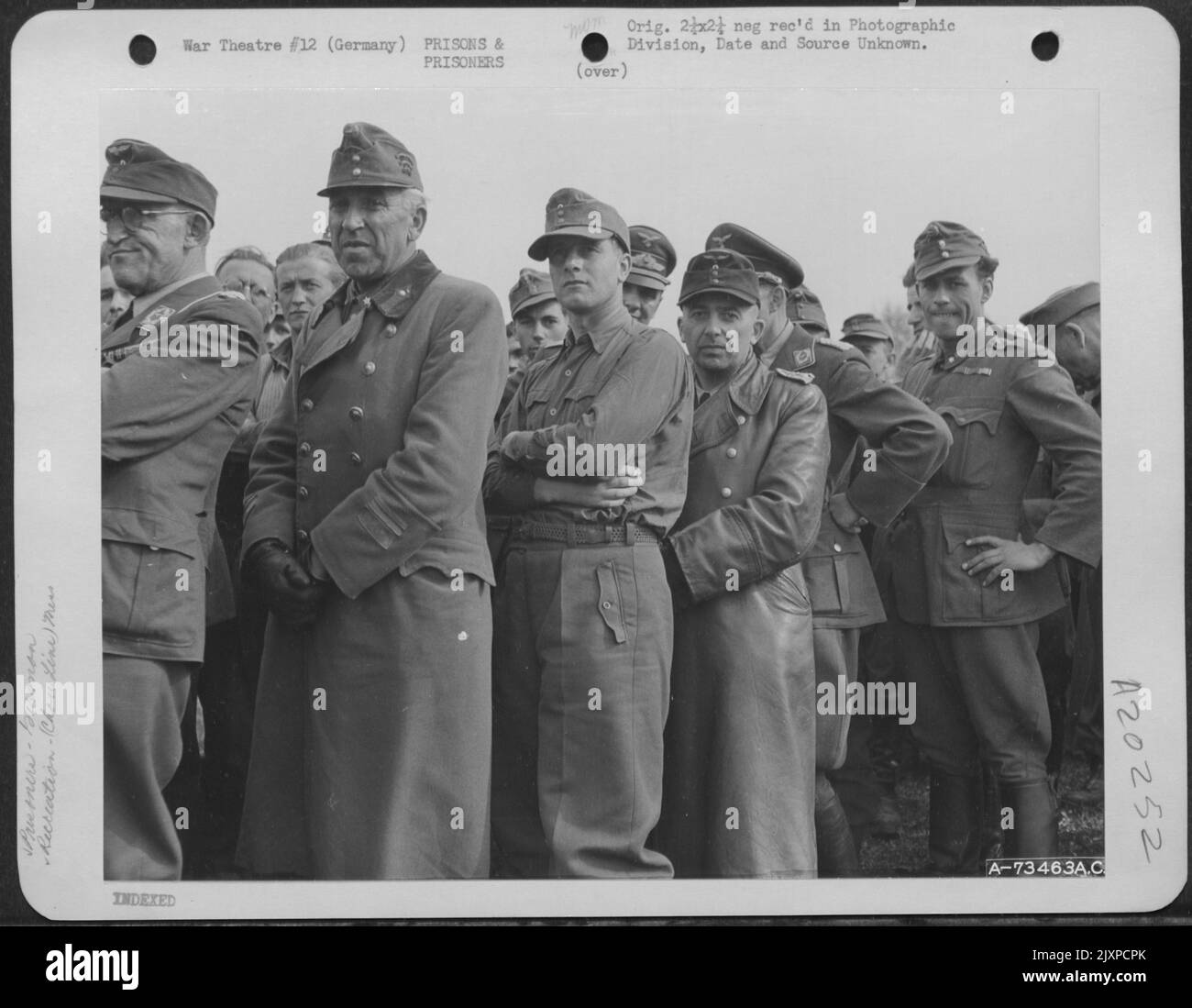 Captured German Officers Standing In Line Waiting For 'C' Rations At The Prisoner Of War Camp Near Hershfeld, Germany. Note Their Arrogance Even After Capture. 18 April 1945. Stock Photo