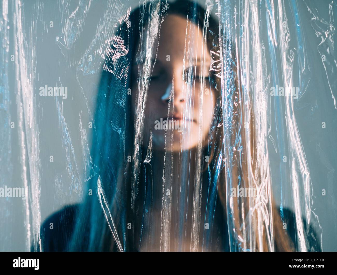 plastic pollution woman drowning polyethylene film Stock Photo