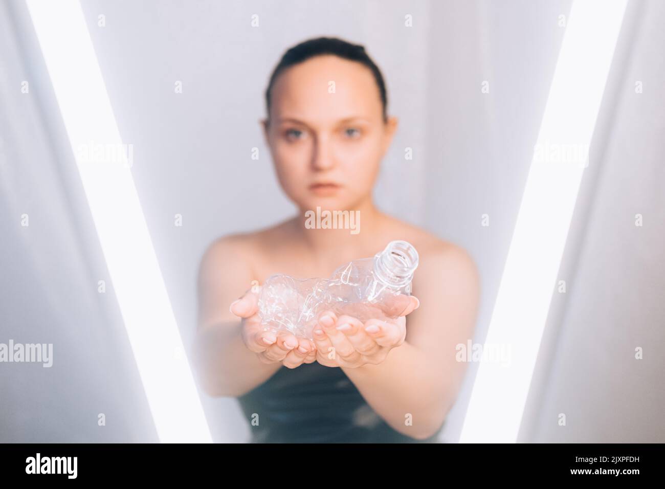 plastic pollution waste recycling bottle woman Stock Photo