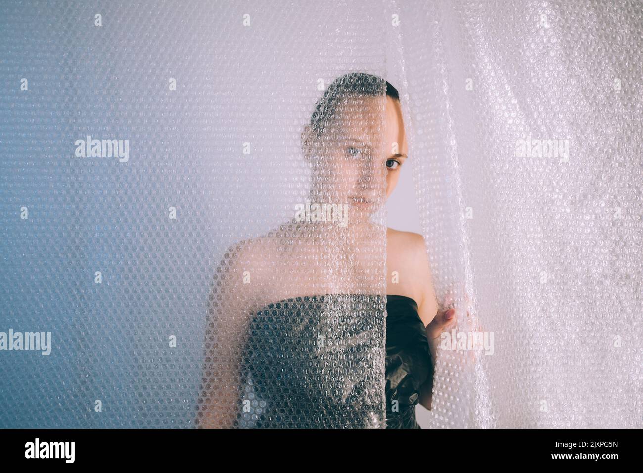 pandemic self isolation worried woman bubble wrap Stock Photo Alamy