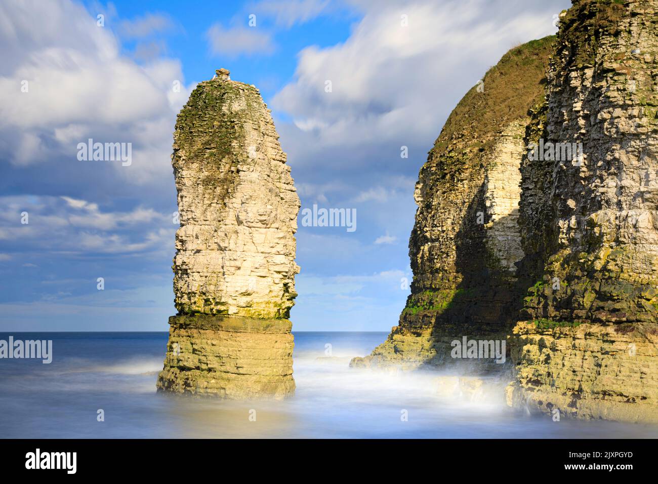 A sea stack in Selwicks Bay near Flamborough Head in Yorkshire captured using a long shutter speed. Stock Photo