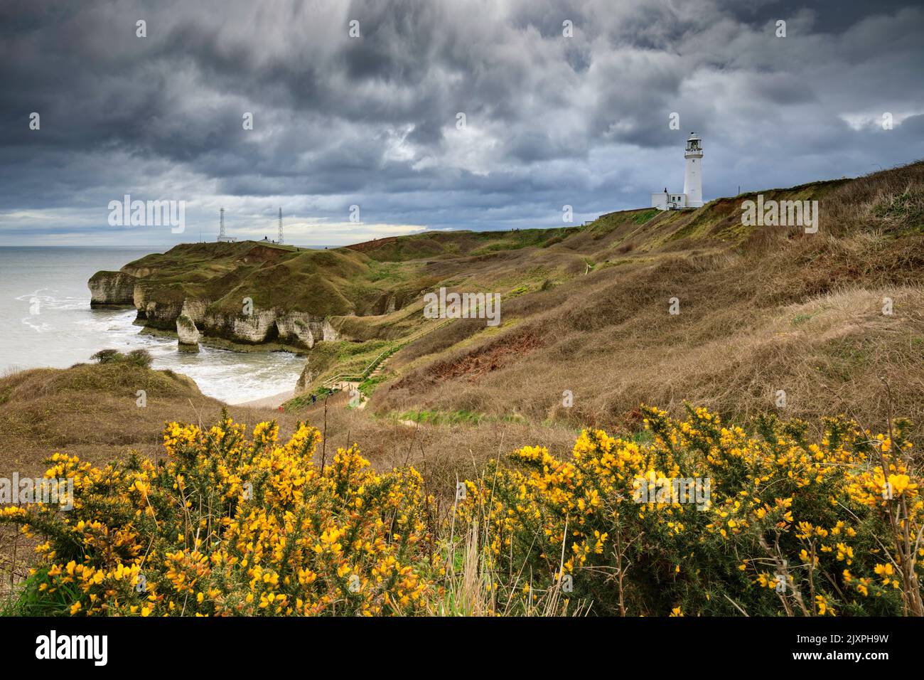 Storm clouds over Flamborough Head Lighthouse and Selwicks Bay in Yorkshire. Stock Photo