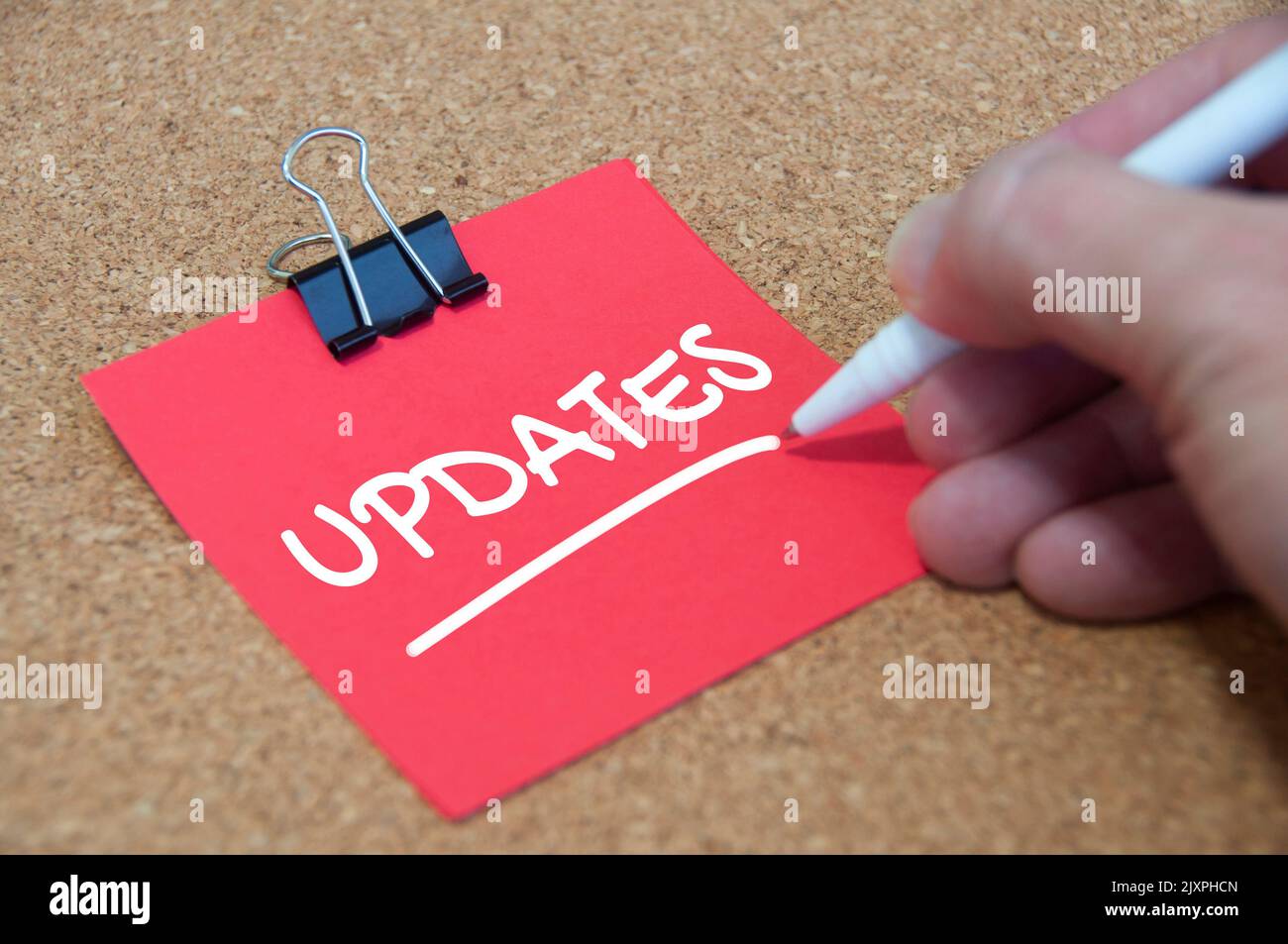 Update text on red notepad with wooden cover background. Update concept. Stock Photo