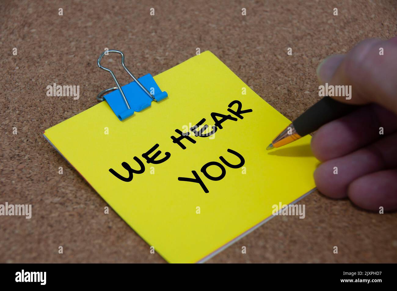 we hear you text on yellow noted. Listening concept. Stock Photo