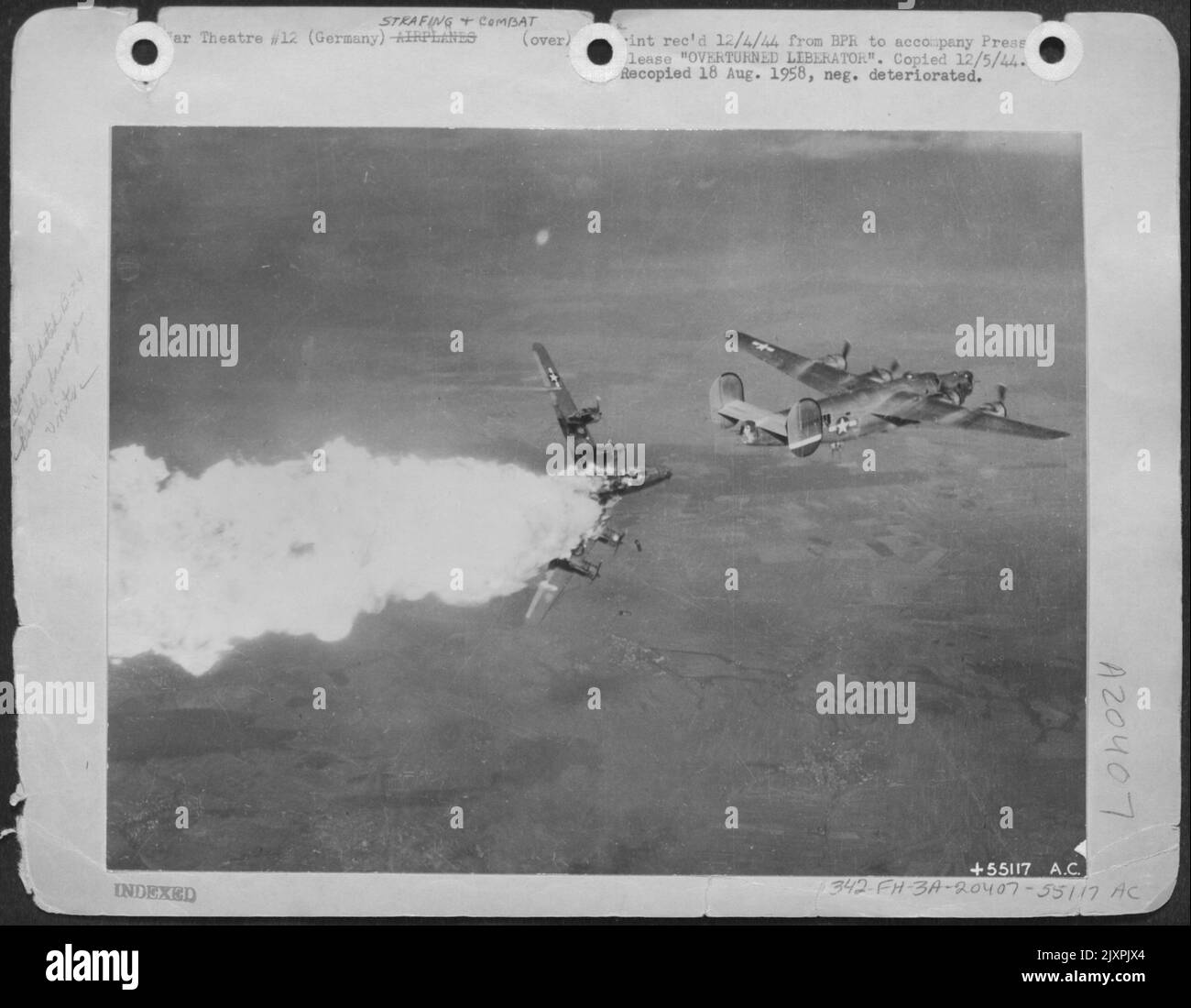 OVERTURNED LIBERATOR-Bombs tumble from the bays of an overturned ...