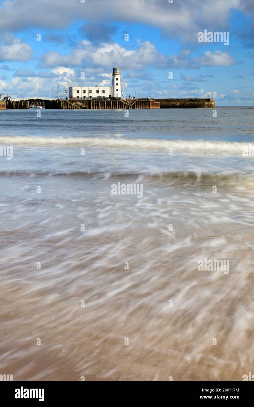 Scarborough Lighthouse captured from South Beach using a long shutter speed. Stock Photo