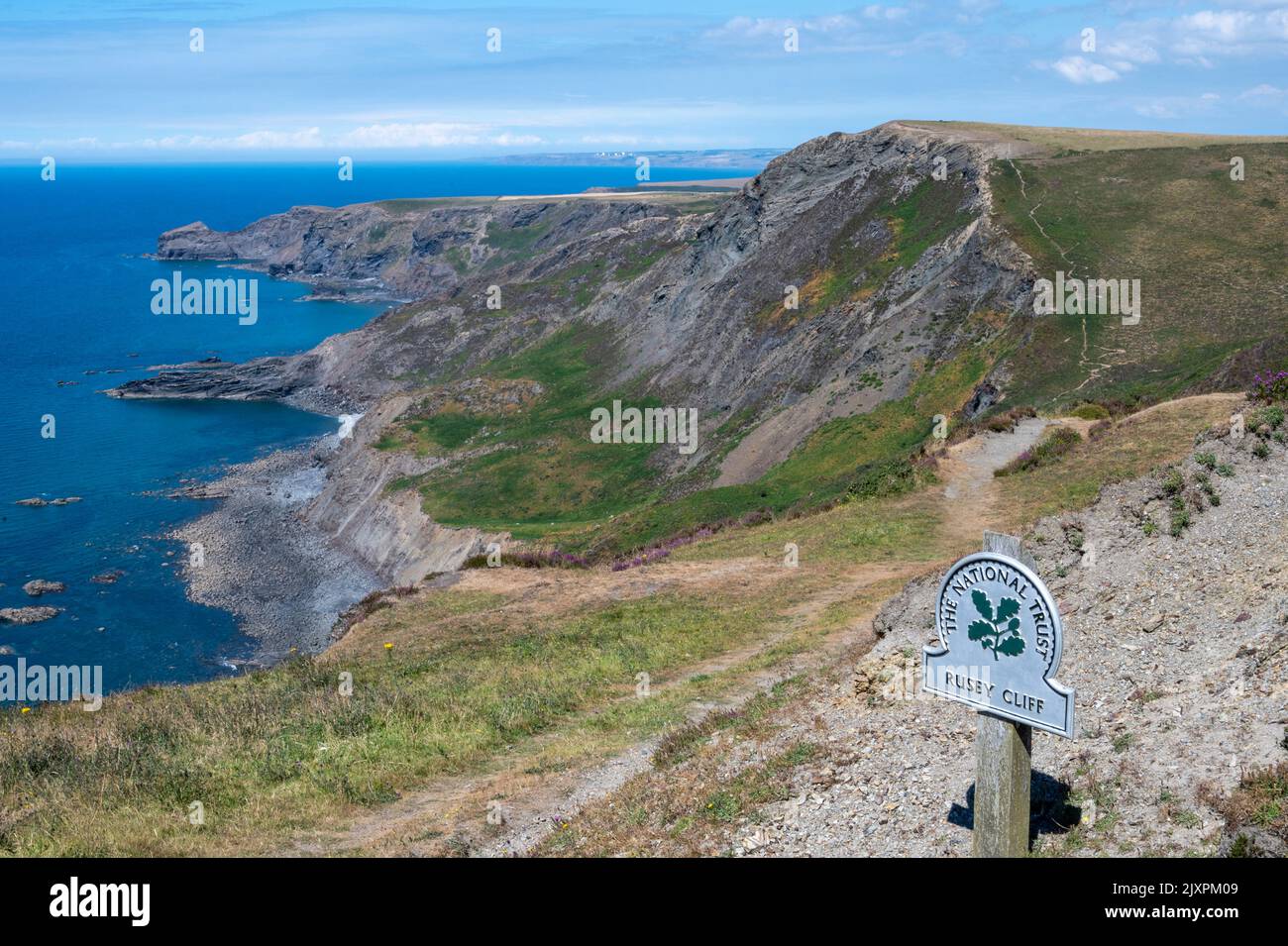 South West Coast Path, North Cornwall, with a view of Cambeak,The Strangles, Rusey Beach from Rusey Cliff. National Trust/ Rusey Cliff sign. Stock Photo