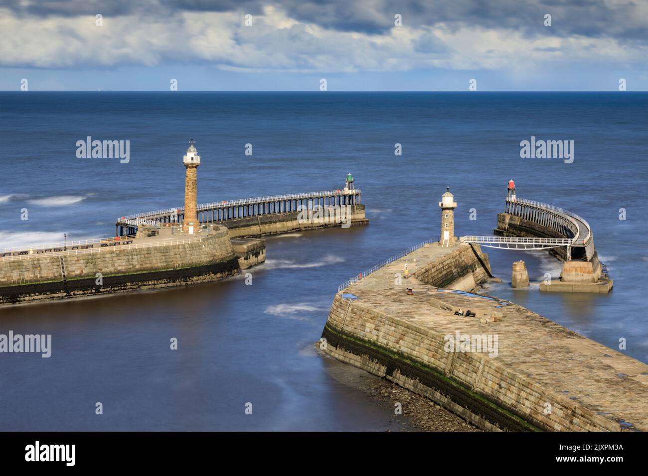 The mouth of Whitby Harbour captured from St Mary's Churchyard using a long shutter speed. Stock Photo