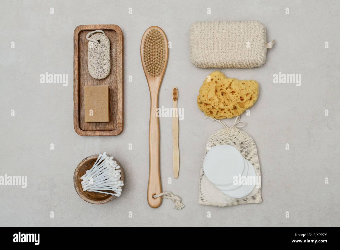 Set of various eco-friendly toiletries on a light concrete background, top view. Organic lifestyle and skin care products. Stock Photo