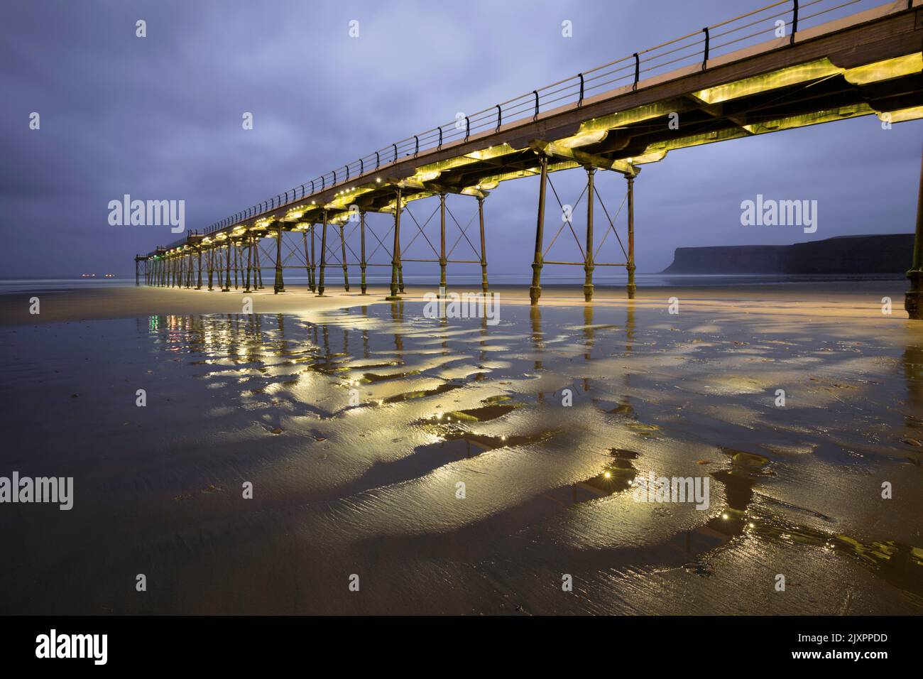 Saltburn Pier captured from the beach during twilight. Stock Photo