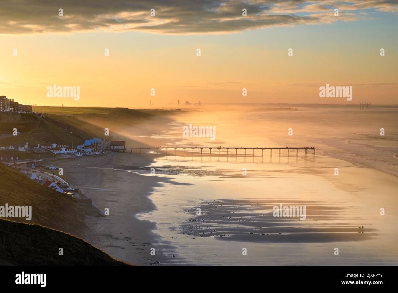Saltburn Pier captured shortly after sunrise from the beach. Stock Photo