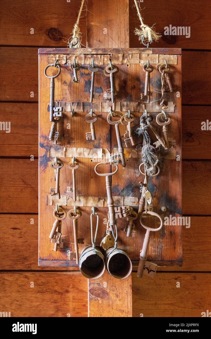 A collection of old keys and measuring cups on a board at the Hook Norton Brewery, Oxfordshire, England Stock Photo