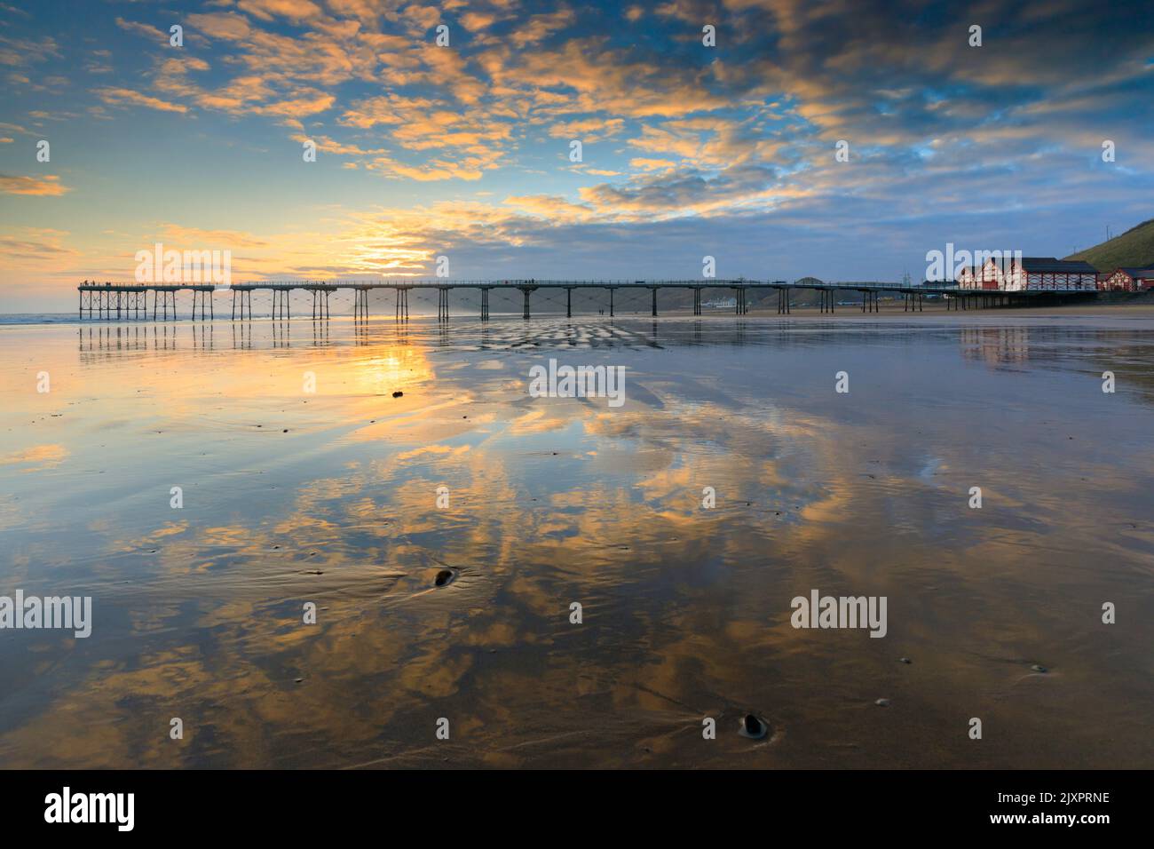 Saltburn Pier captured shortly after sunrise from the beach. Stock Photo