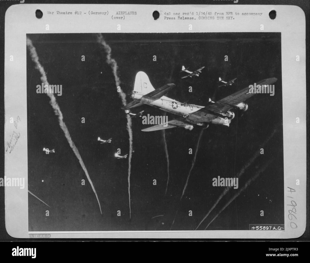 U.S. Army 8th Air Force fighters streak through a Boeing B-17 Flying Fortress formation to comb the sky for possible enemy planes as the big fellows fly on over northern Germany to attack transportation facilities. 96th Bomb Group. Stock Photo