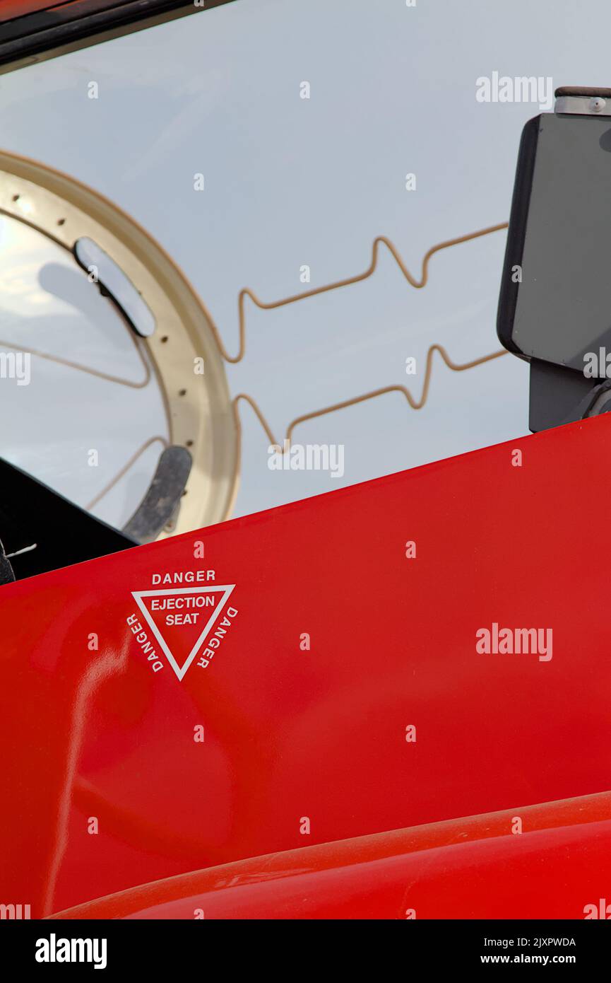 Danger Ejection Seat Sticker On The Side Of A Red Arrows Hawk T1 Aerobatic Display Jet Showing The Explosive Cord On The Canopy. Bournemouth UK Stock Photo