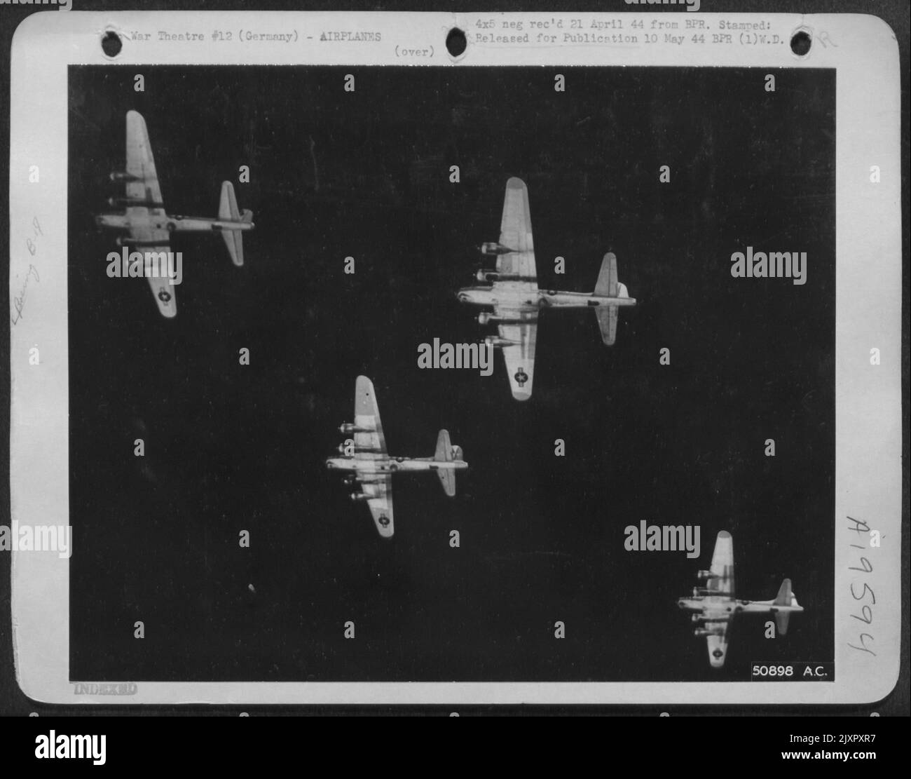 Silver Wings--Four Flying Fortresses of the U.S. 8th A.A.F. are silhouetted as they roared toward the Reich capital city of Berlin on April 29th. Stock Photo