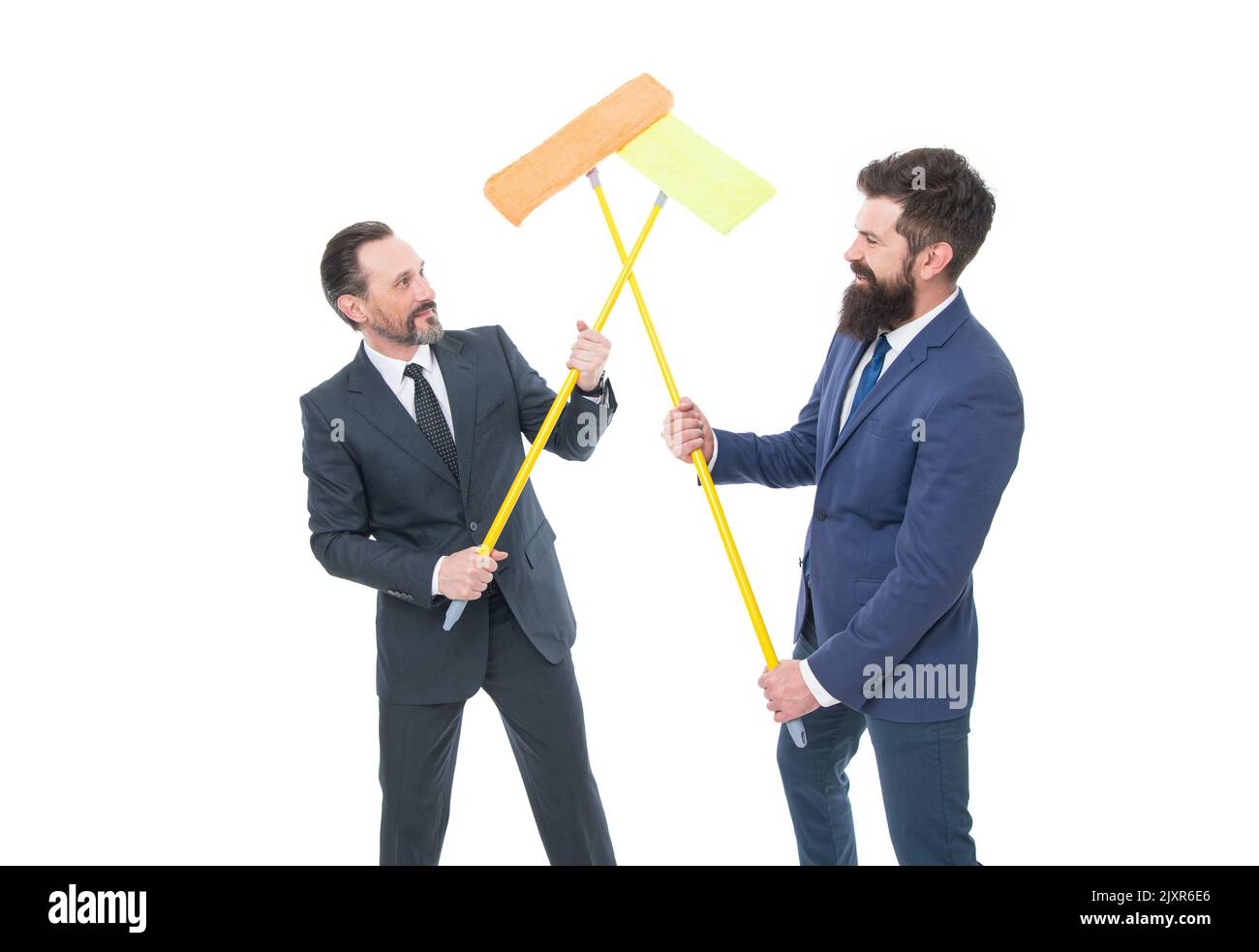 mature bearded men in suit hold householding mop. Partnership and teamwork. businessmen clear wall to white with householding mop. clean slate Stock Photo