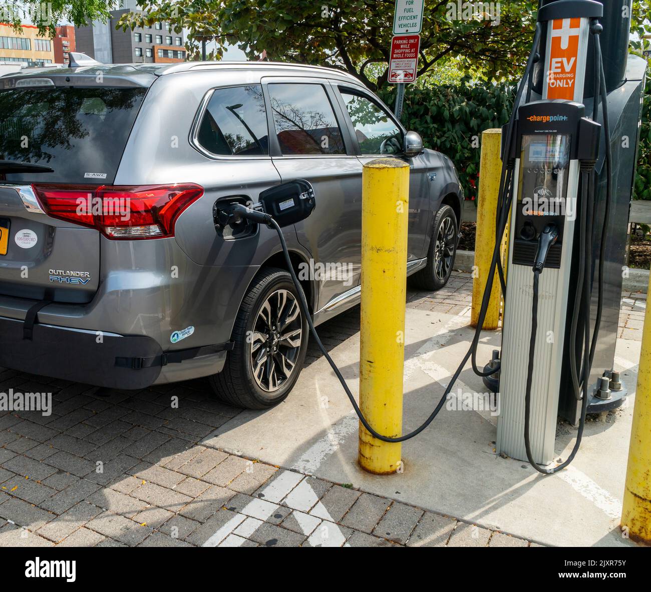 A Mitsubishi Outlander PHEV  plug in hybrid vehicle is charged at a public charging station in Brooklyn in New York on Saturday, September 3, 2022. (© Richard B. Levine) Stock Photo